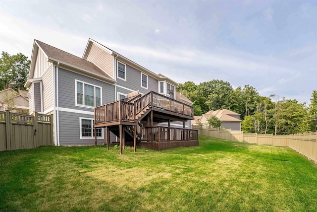 back of house with a yard and a deck