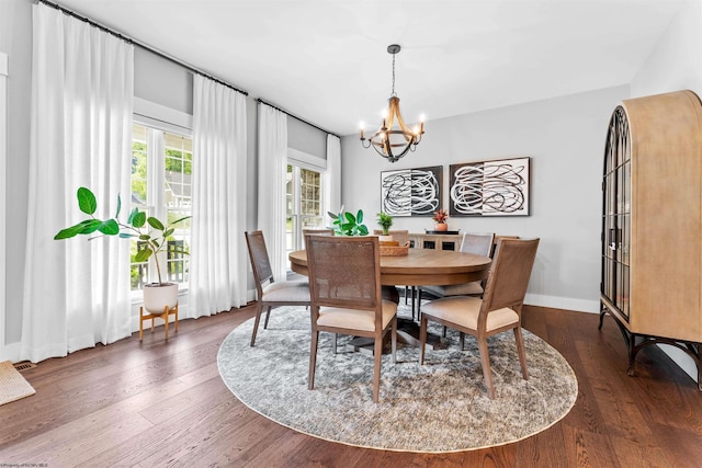 dining room featuring a chandelier and dark wood-type flooring