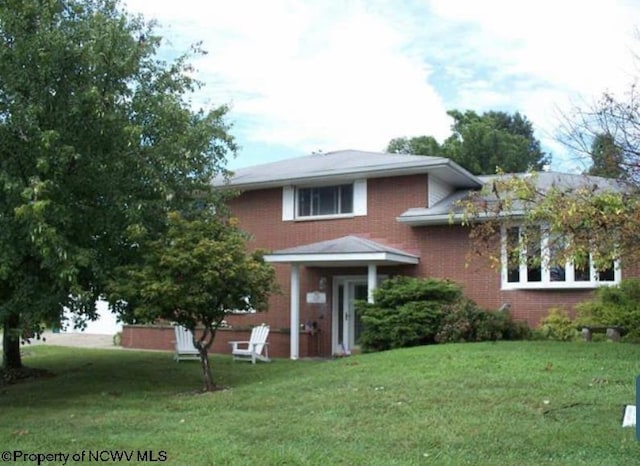 view of front of property with brick siding and a front yard