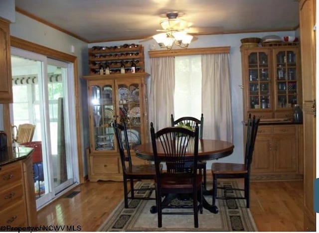 dining space with plenty of natural light, light wood-style flooring, crown molding, and ceiling fan