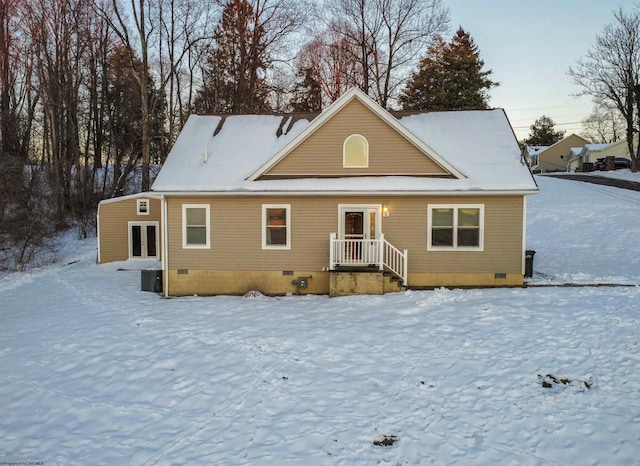 snow covered rear of property featuring french doors