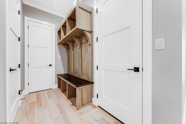 mudroom featuring light wood-type flooring and ornamental molding