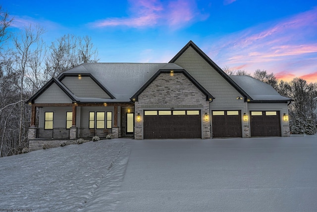 craftsman house featuring covered porch and a garage