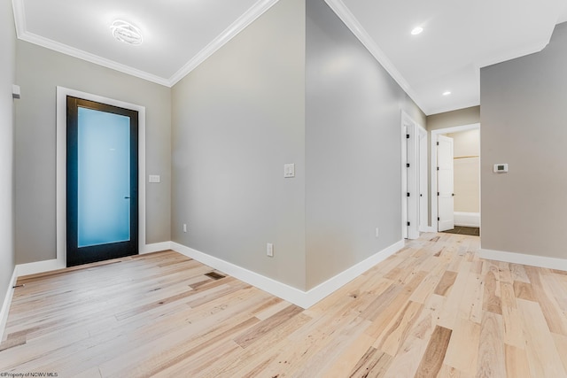 entryway with ornamental molding and light wood-type flooring