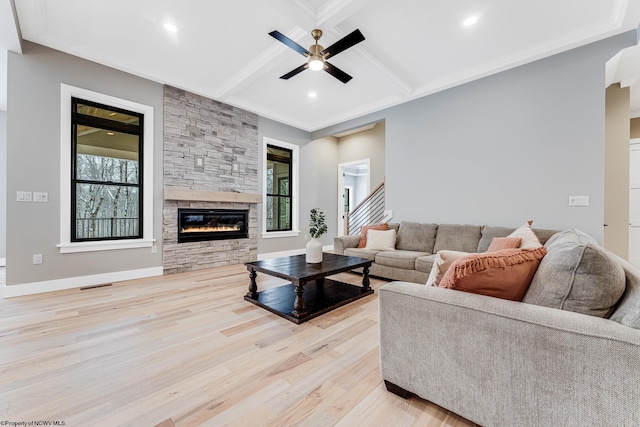 living room with beam ceiling, ornamental molding, light hardwood / wood-style floors, and coffered ceiling