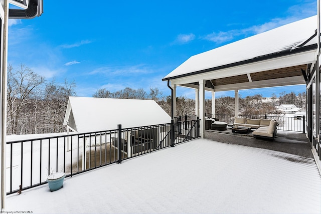 snow covered deck with an outdoor living space