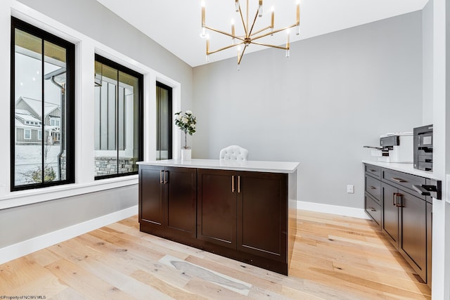 interior space with an inviting chandelier and light hardwood / wood-style flooring