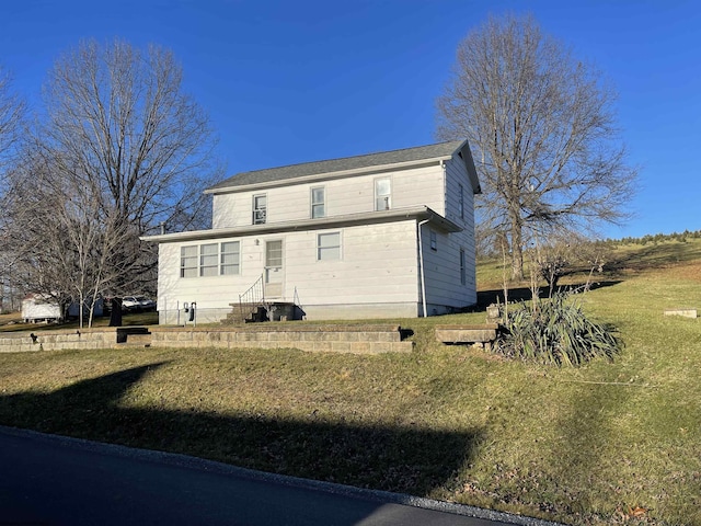 rear view of property with a lawn