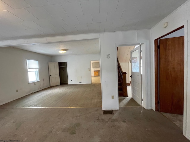 empty room featuring beamed ceiling