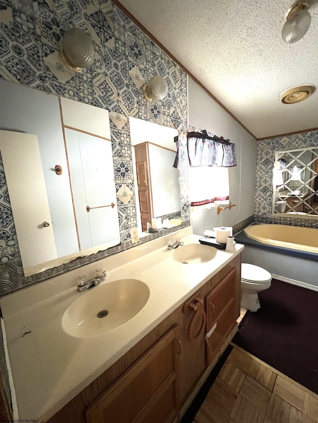 bathroom with toilet, a tub, a textured ceiling, vaulted ceiling, and vanity