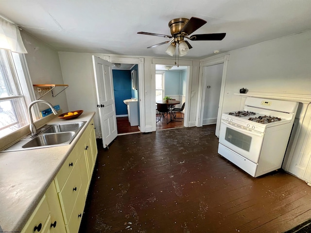 kitchen featuring sink, white gas range oven, ceiling fan, and plenty of natural light