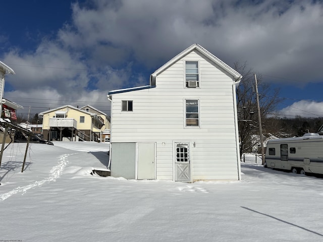 snow covered property featuring cooling unit