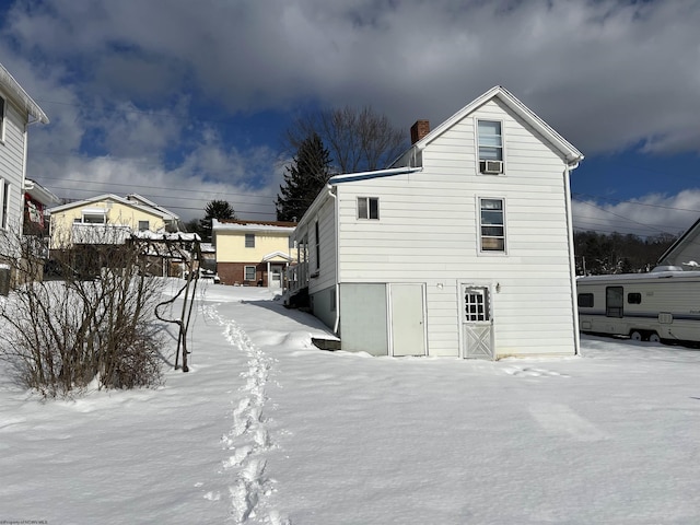 snow covered property featuring cooling unit