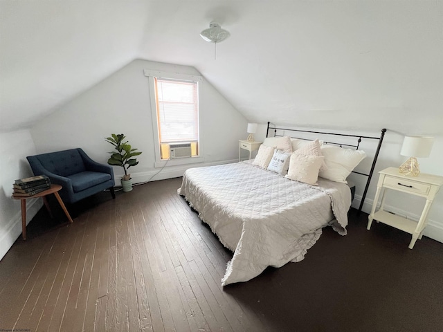 bedroom with cooling unit, vaulted ceiling, and dark hardwood / wood-style floors