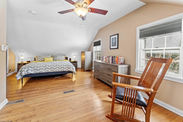 bedroom featuring lofted ceiling, ceiling fan, and light wood-type flooring