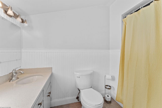 bathroom featuring toilet, tile patterned flooring, and vanity