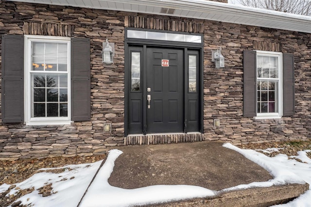 view of snow covered property entrance