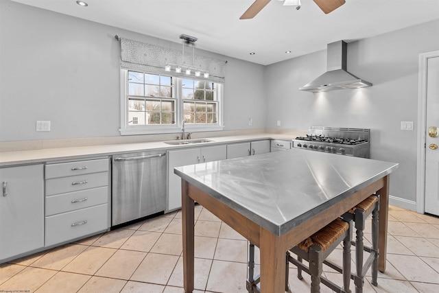 kitchen featuring sink, dishwasher, wall chimney exhaust hood, range, and pendant lighting