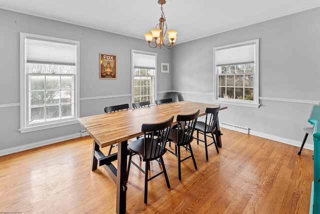 dining space featuring a notable chandelier and light hardwood / wood-style floors