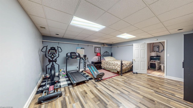 unfurnished bedroom featuring a paneled ceiling and hardwood / wood-style flooring