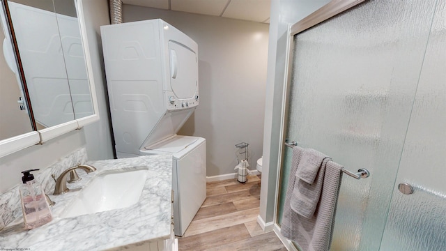 bathroom with a shower with door, hardwood / wood-style floors, vanity, and toilet