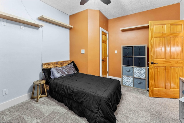 carpeted bedroom featuring ceiling fan and a textured ceiling