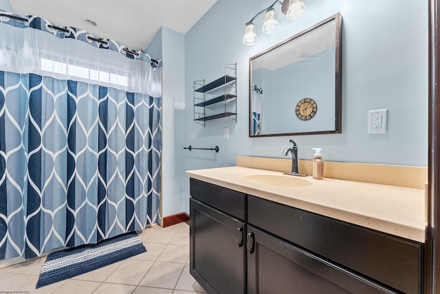 bathroom featuring walk in shower, vanity, and tile patterned flooring