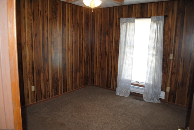 9412 Morgantown Pike, Philippi, WV 26416 - spare room with wood walls, a ceiling fan, and carpet flooring