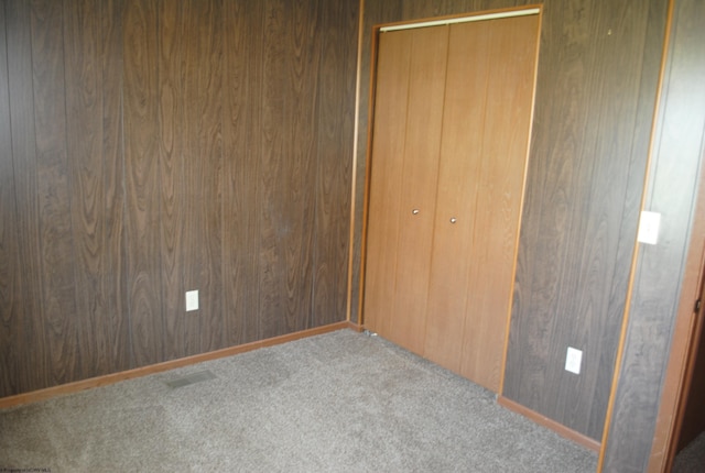 9412 Morgantown Pike, Philippi, WV 26416 - unfurnished bedroom with carpet floors, a closet, visible vents, and wood walls