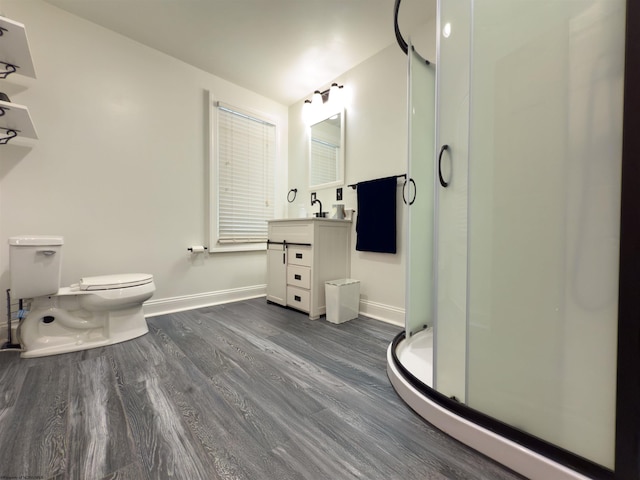 bathroom featuring vanity, toilet, wood-type flooring, and walk in shower