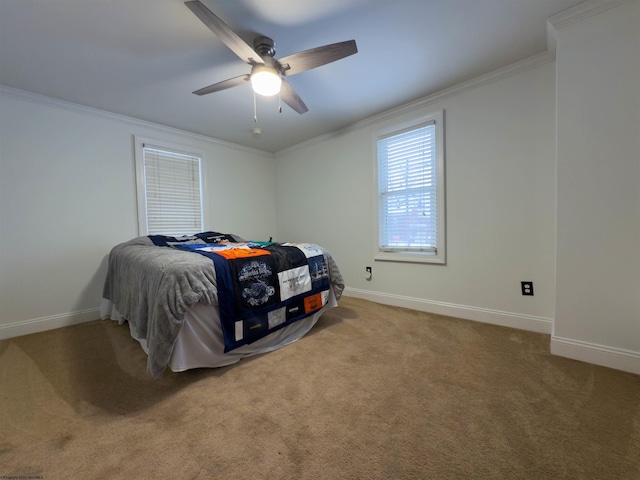 carpeted bedroom with ceiling fan and crown molding