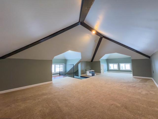 bonus room with carpet and lofted ceiling with beams