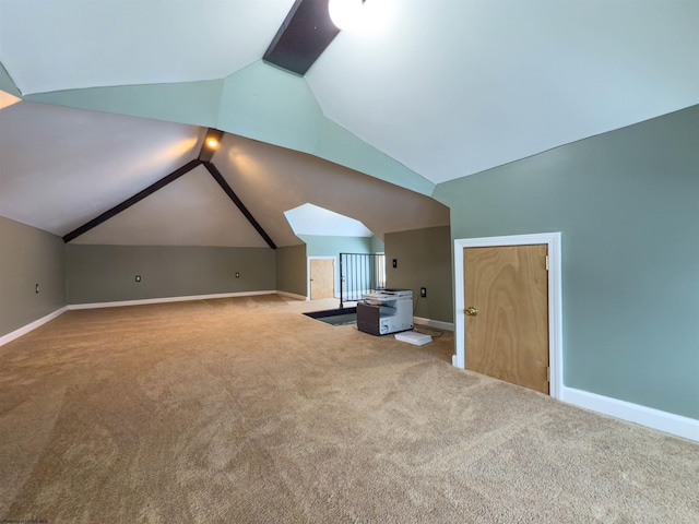 additional living space featuring vaulted ceiling and light colored carpet