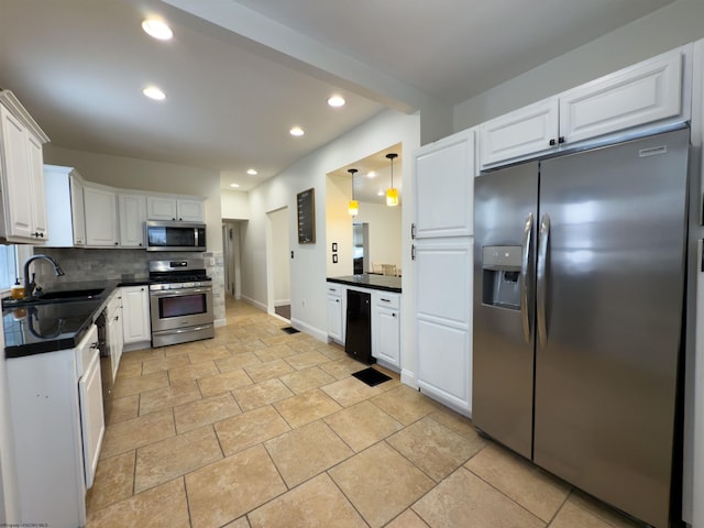 kitchen with white cabinetry, appliances with stainless steel finishes, backsplash, decorative light fixtures, and sink