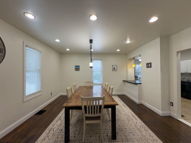 dining room with dark wood-type flooring