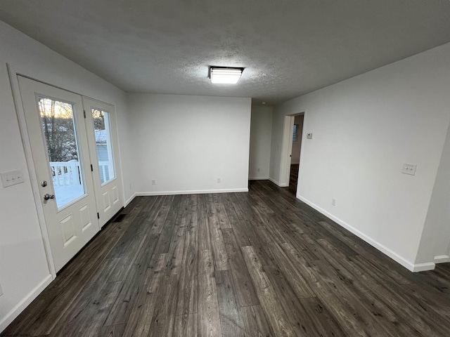 interior space featuring dark wood-type flooring and a textured ceiling