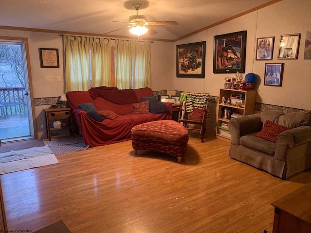 living room with hardwood / wood-style flooring, ceiling fan, lofted ceiling, a textured ceiling, and crown molding