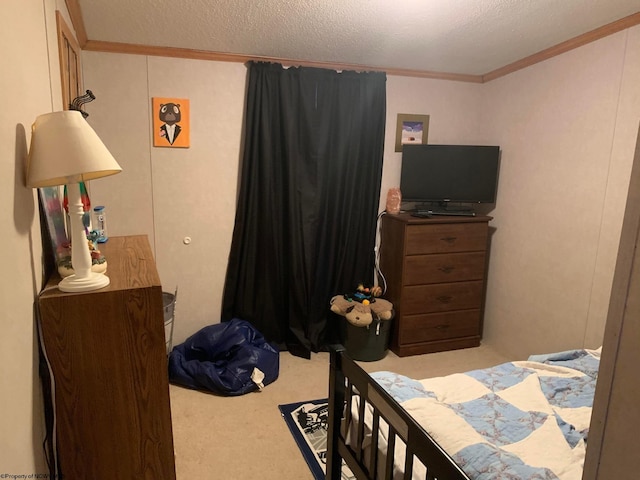 carpeted bedroom with a textured ceiling and ornamental molding