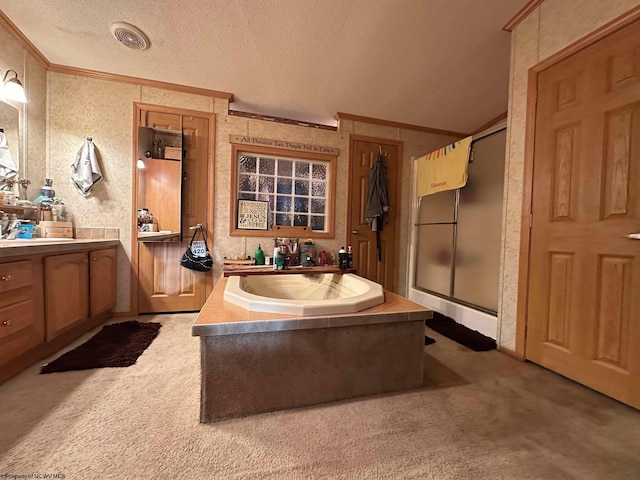 bathroom with a textured ceiling, vanity, ornamental molding, and plus walk in shower