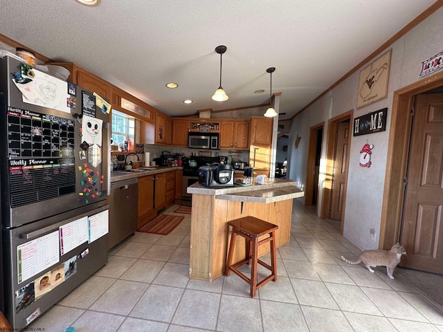 kitchen featuring pendant lighting, appliances with stainless steel finishes, a textured ceiling, a kitchen island, and sink