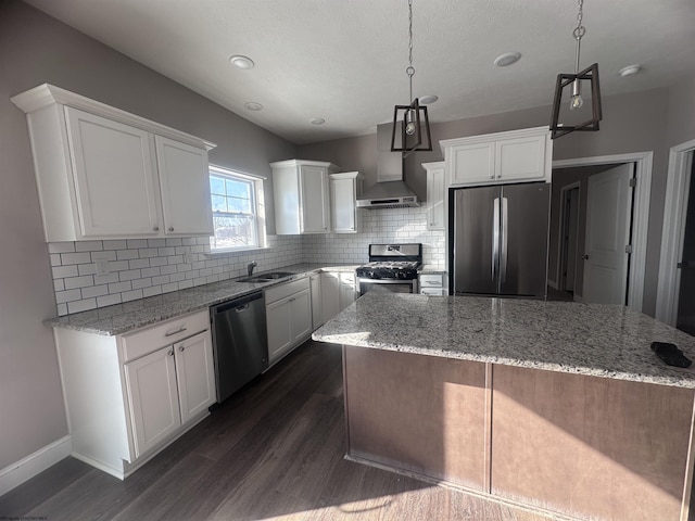 kitchen with stainless steel appliances, white cabinets, and decorative light fixtures