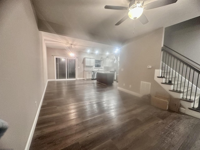 unfurnished living room featuring ceiling fan and dark hardwood / wood-style flooring