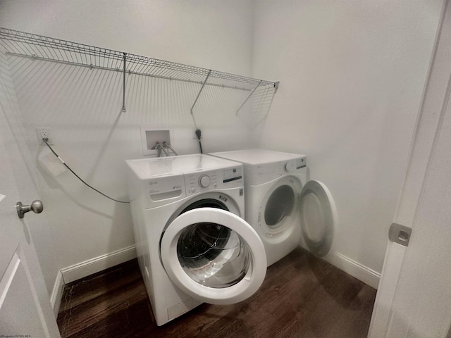 clothes washing area featuring washer and clothes dryer and hardwood / wood-style floors