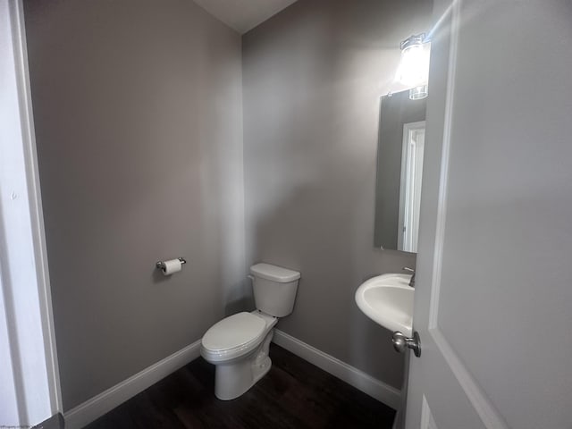 bathroom with sink, hardwood / wood-style flooring, and toilet