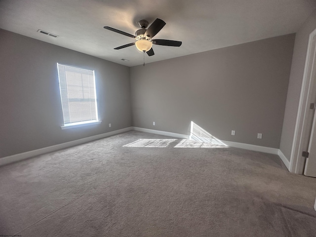 unfurnished room with ceiling fan and carpet floors