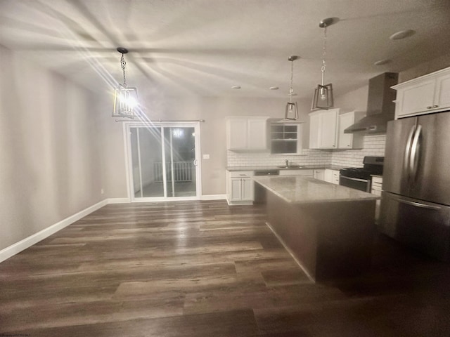 kitchen featuring stainless steel range, a kitchen island, pendant lighting, wall chimney range hood, and white cabinets