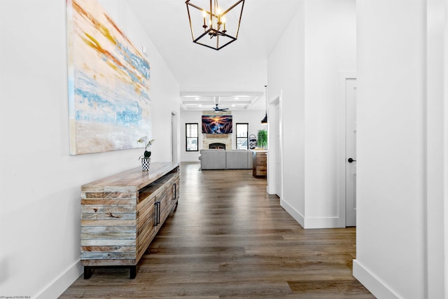 corridor featuring dark hardwood / wood-style flooring and a chandelier