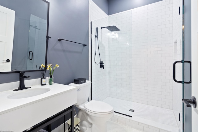 bathroom with a shower with door, tile patterned floors, vanity, and toilet