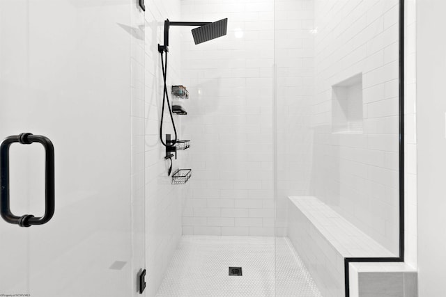 bathroom with a shower with shower door