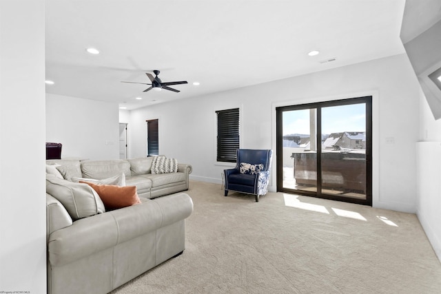 carpeted living room featuring ceiling fan